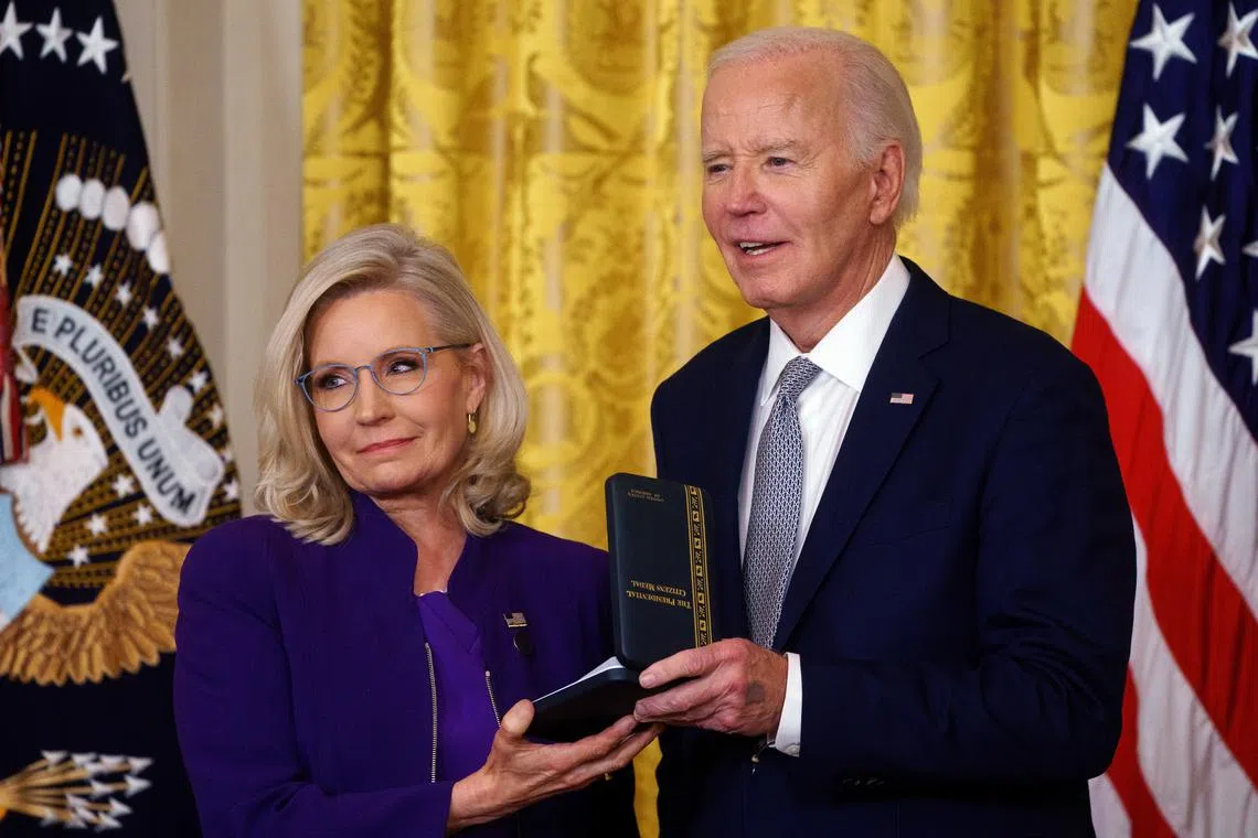 US President Joe Biden presents the Presidential Citizens Medal to former US Representative Liz Cheney, during a ceremony at the White House, on Jan 2.