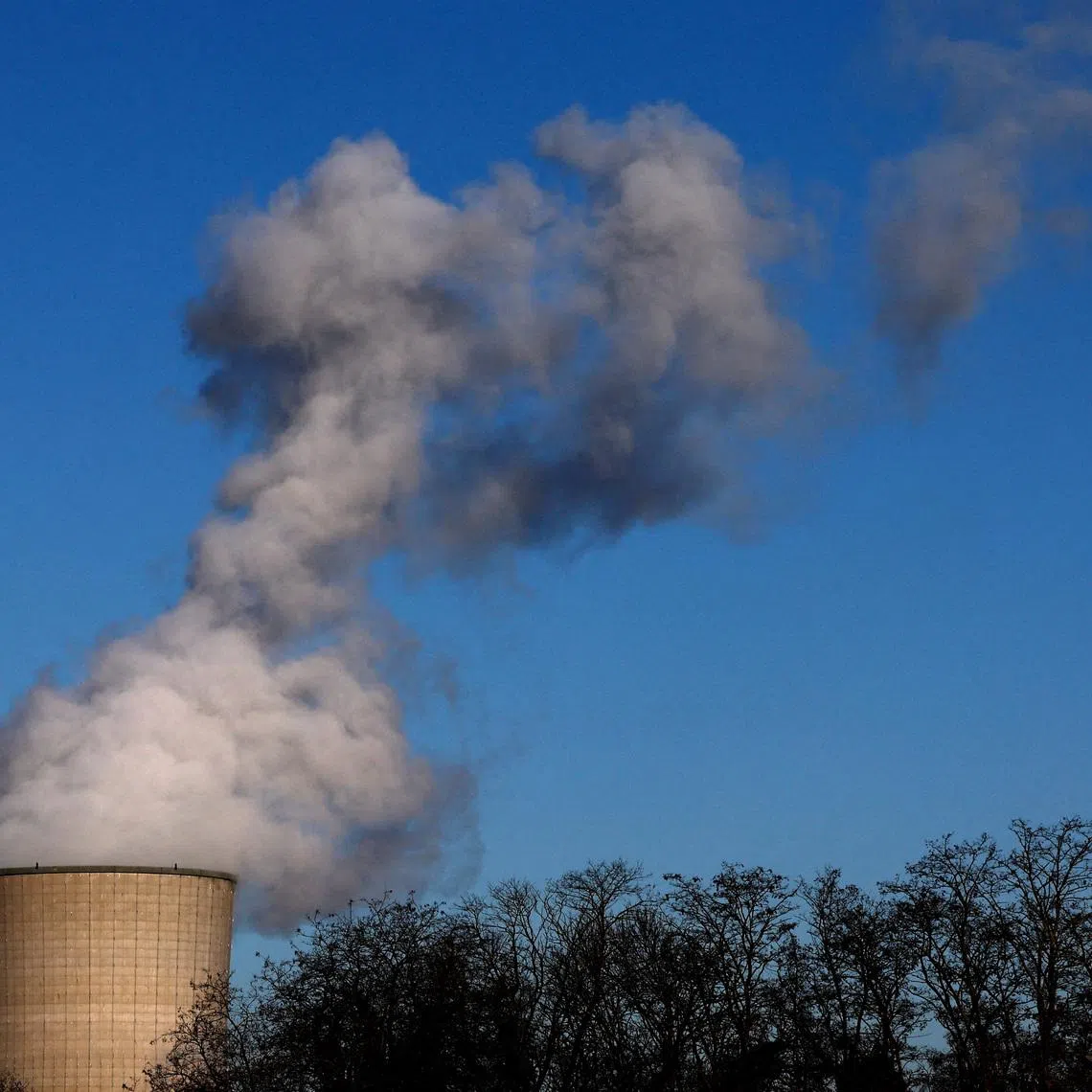 FILE PHOTO: Smoke billows from a chimney at a combined-cycle gas turbine power plant in Drogenbos, Belgium January 16, 2024. REUTERS/Yves Herman/File Photo