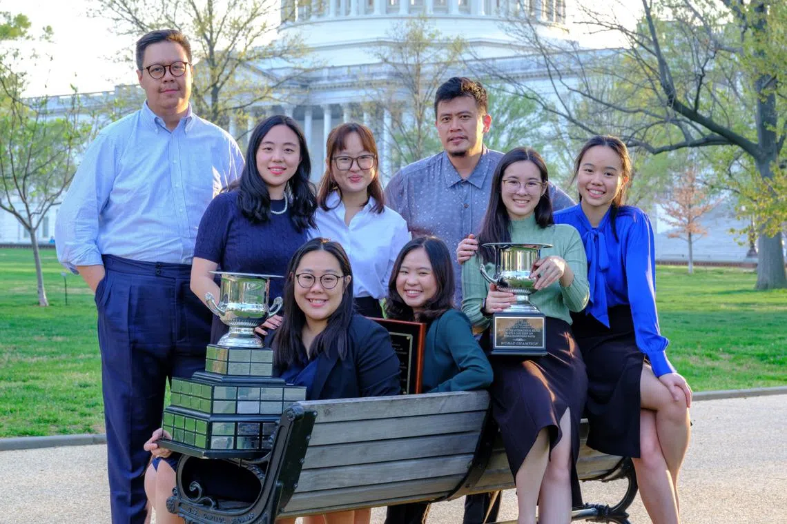 The winning team from the Singapore Management University with the trophy in Washington DC.
