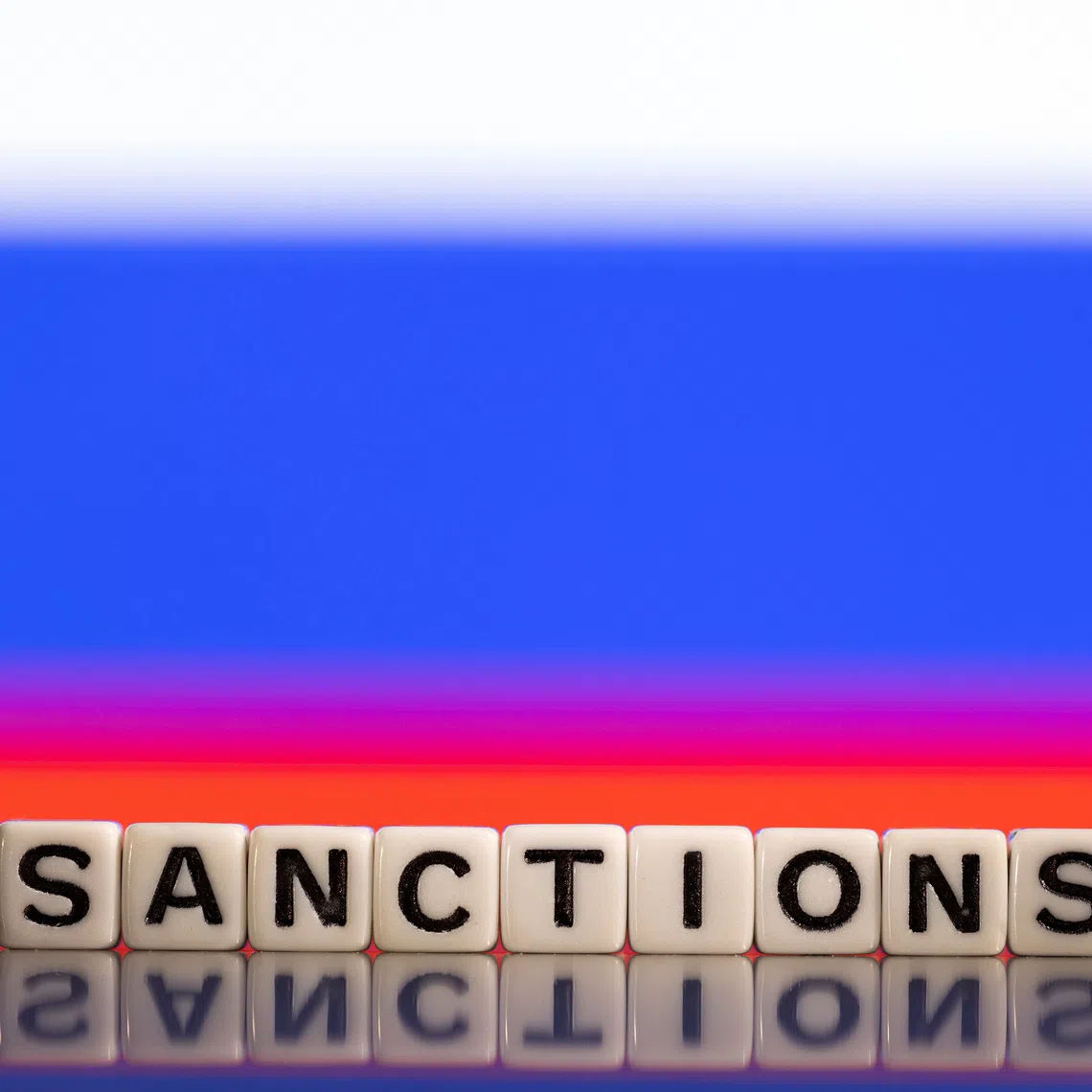 Plastic letters arranged to read \"Sanctions\" are placed in front of Russian flag colors in this illustration taken February 25, 2022. REUTERS/Dado Ruvic/Illustration