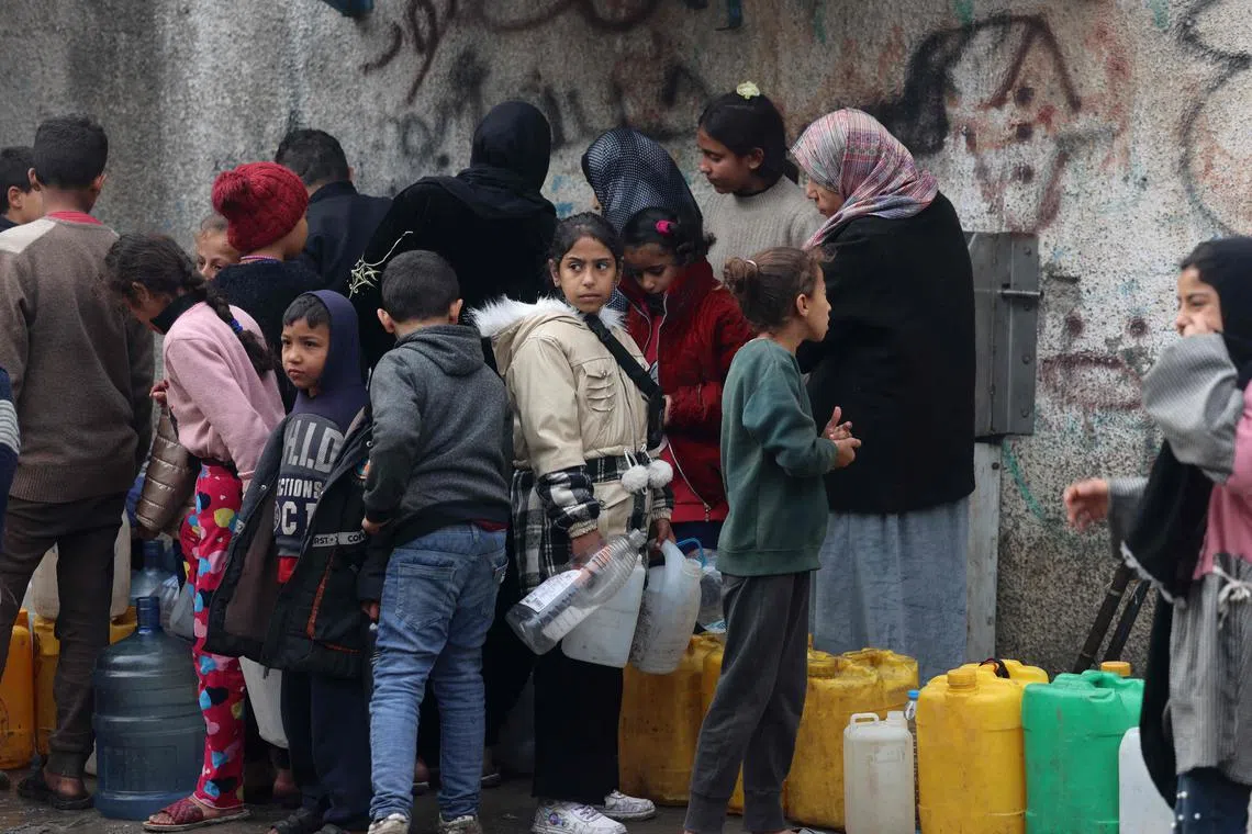 Women and children queue for water in Rafah, in the southern Gaza Strip.