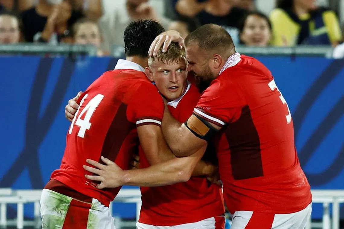 FILE PHOTO: Rugby Union - Rugby World Cup 2023 - Pool C - Wales v Fiji - Matmut Atlantique, Bordeaux, France - September 10, 2023 Wales' Louis Rees-zammit celebrates scoring their third try with teammates Jac Morgan and Tomas Francis REUTERS/Stephane Mahe/File Photo
