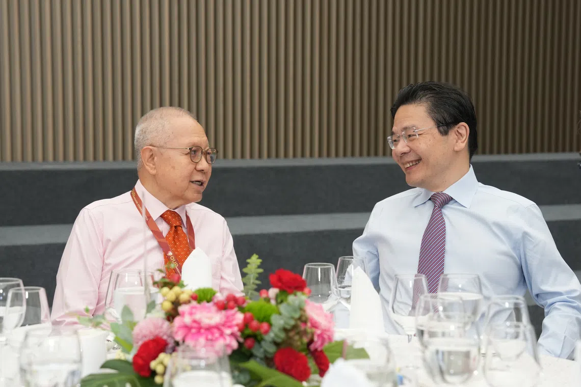 Prime Minister Lawrence Wong (right) interacting with Security and Intelligence Division alumnus Mr Eddie Teo.