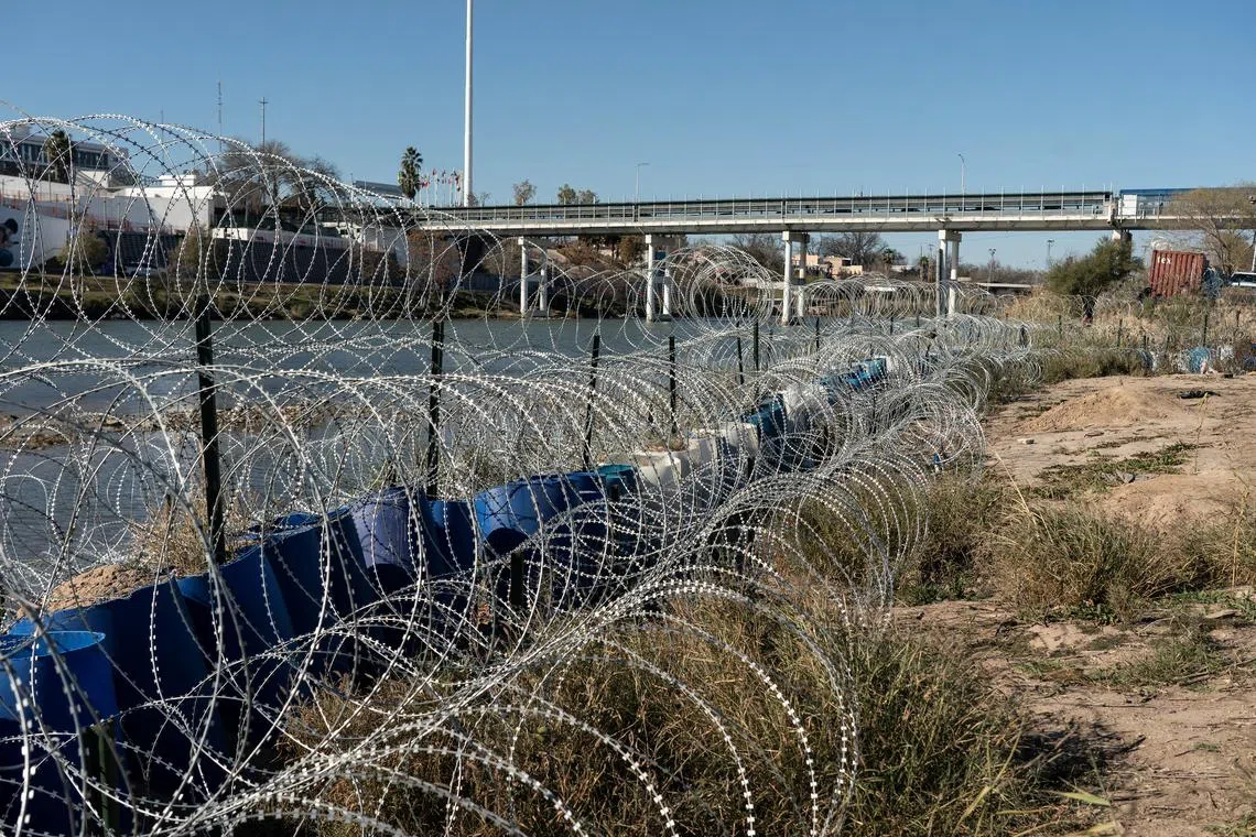 Concertina wire fence is seen on the bank of the Rio Grande in Eagle Pass, Texas. The US Supreme Court voted to let the Biden administration remove the barriers.