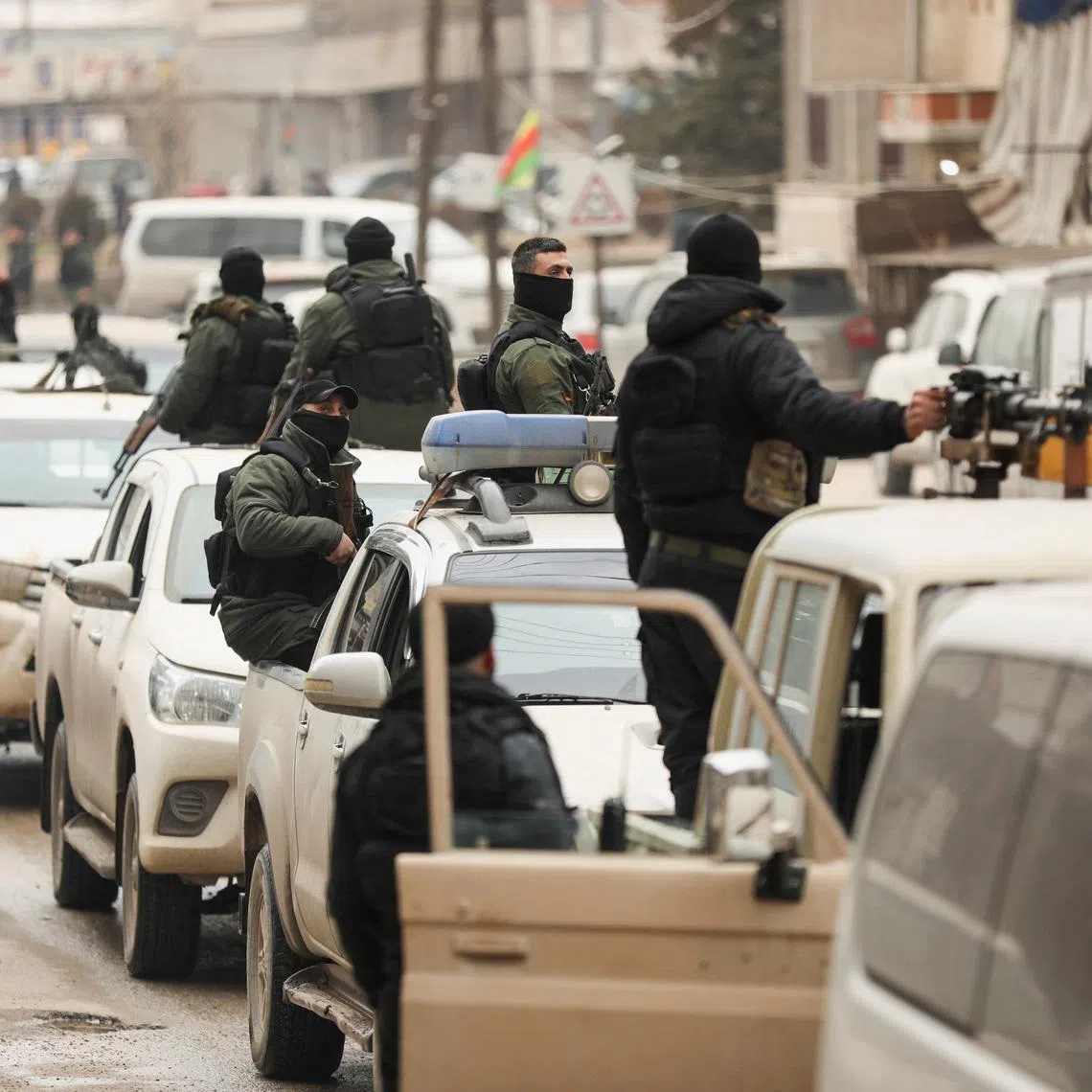 Members of the Kurdish Internal Security Forces wait for the arrival of the security forces of the Syrian government during the curfew, following an agreement between the Syrian Democratic Forces and the Syrian government, in Qamishli, Syria, February 3, 2026. REUTERS/Orhan Qereman