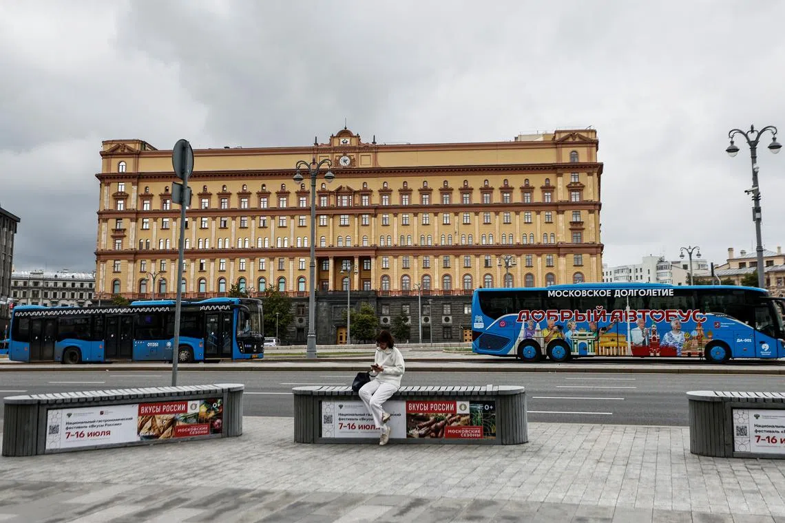 FILE PHOTO: A woman uses her mobile phone in front of the Federal Security Service (FSB) building on Lubyanka Square in Moscow, Russia, June 24, 2023. REUTERS/Maxim Shemetov/File Photo