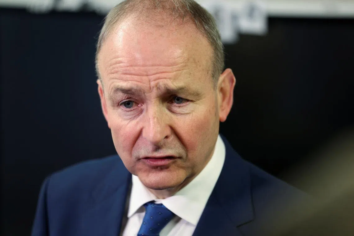 FILE PHOTO: Ireland's Tanaiste (Deputy Prime Minister) and leader of Fianna Fail, Micheal Martin speaks to the media after voting at a polling station in St. Anthony's Boys National school, during Ireland's general election, in Cork, Ireland, November 29, 2024. REUTERS/Damien Eagers/File Photo