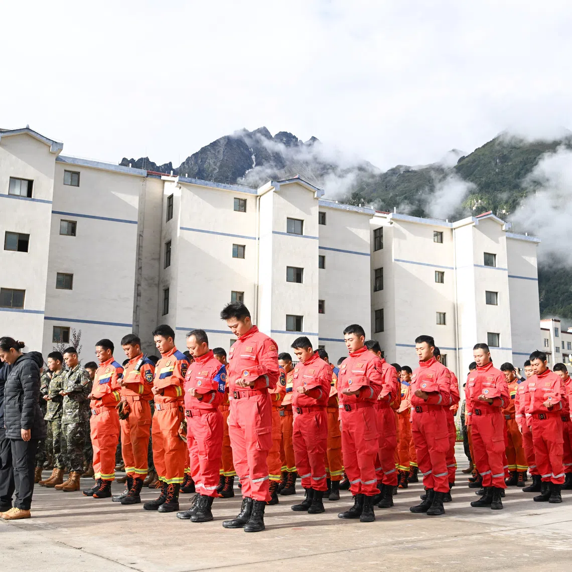 Rescue workers, local officials and residents stand in silence during a memorial service to mourn the victims of the August 26 mudslide, in Gyirong county, Shigatse, Tibet Autonomous Region, China September 1, 2026. cnsphoto via REUTERS