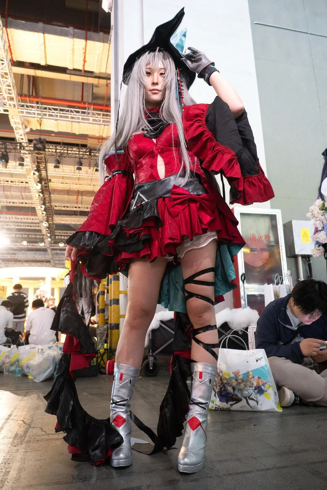 Stacy Liu, cosplaying as Skadi the Corrupting Heart from the mobile game Arknights, poses for photos during the Hypergryph Carnival at the National Exhibition and Convention Center.