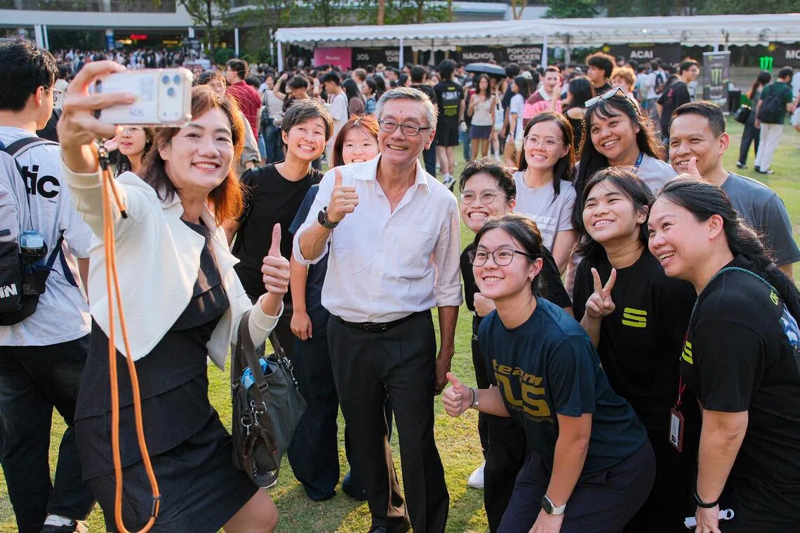 NUS president Tan Eng Chye with students and colleagues at Supernova 2026.