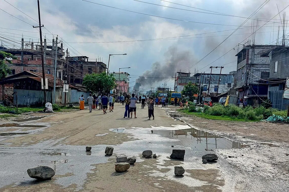Smoke billows from a street after a standoff between mob and security forces at Sekhon in Imphal East during ongoing ethnic violence in India's north-eastern Manipur state on June 15, 2023.