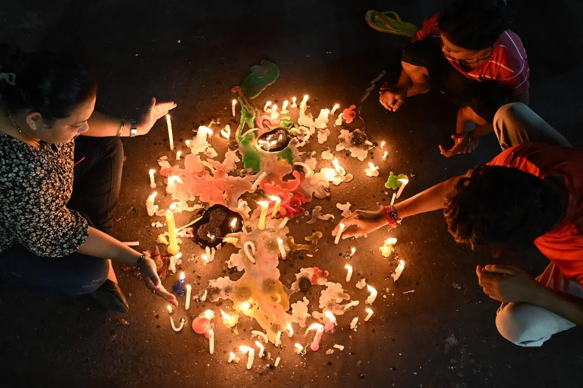 People light candles as they take part in a protest against the rape and murder of a doctor, at the RG Kar Medical College and Hospital in Kolkata, on Sept 4, 2024.