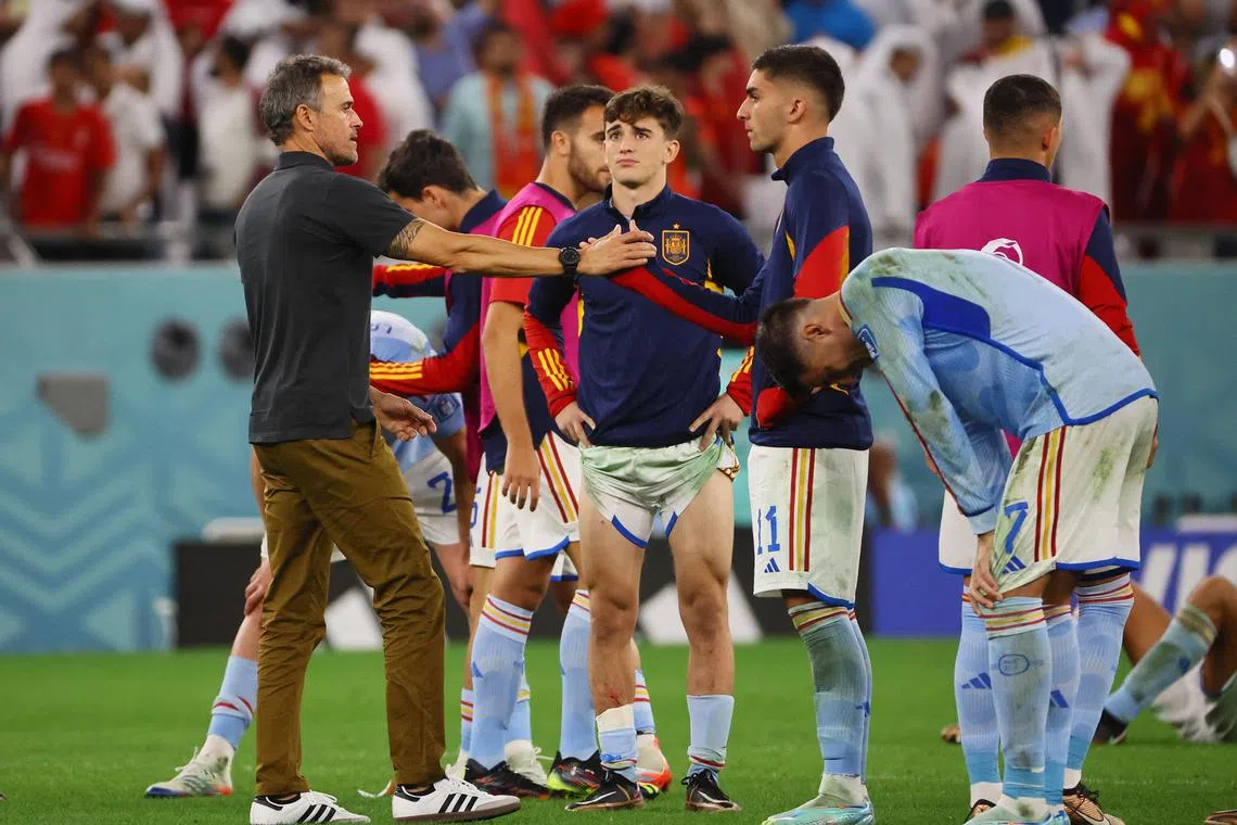Spain coach Luis Enrique (left) with Gavi and other players after they exited the World Cup at the hands of Morocco on Tuesday. 