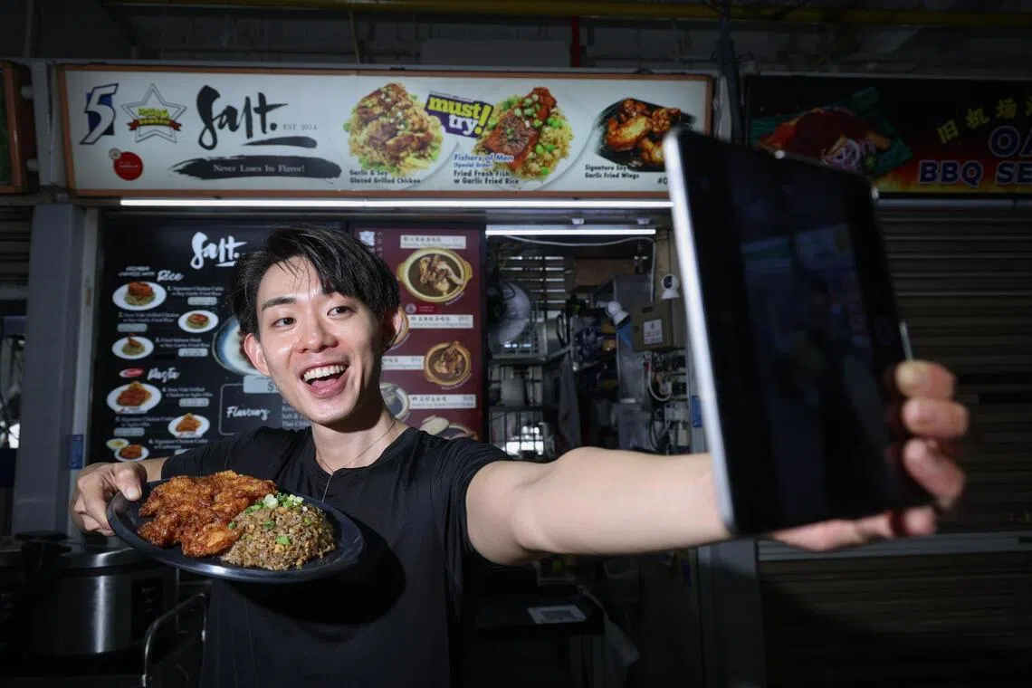 Stall owner Kenny Ngoo generates content for his stall’s social media accounts. 