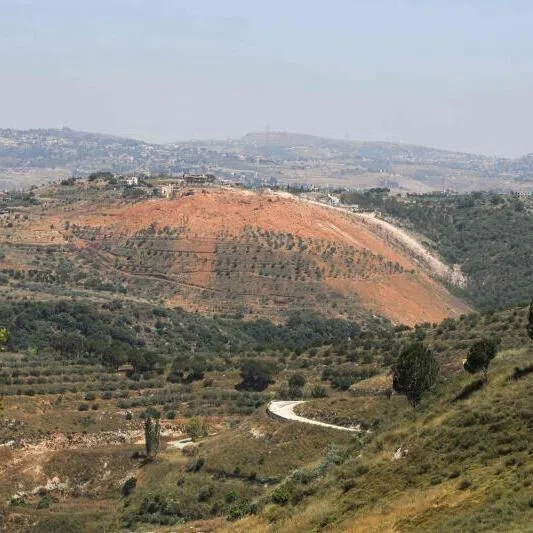 A photograph taken from the southern village of Ghandouriyeh on June 16 showing ejecta scattered around a crater reportedly left by the Israeli detonation of a Hezbollah tunnel network in Qantara.
