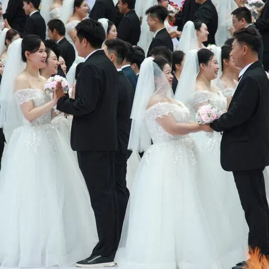 Couples at a collective wedding ceremony in Shenyang. In China’s cut-throat marriage market, cars, houses and savings are all topics for a first date. More offbeat is the number of siblings.