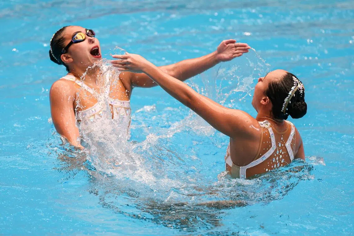 (From left) Singapore’s artistic swimmers Debbie Soh and Yvette Chong competing in the women’s duet final at the Assumption University Aquatic  Center in Bangkok on Dec 12.