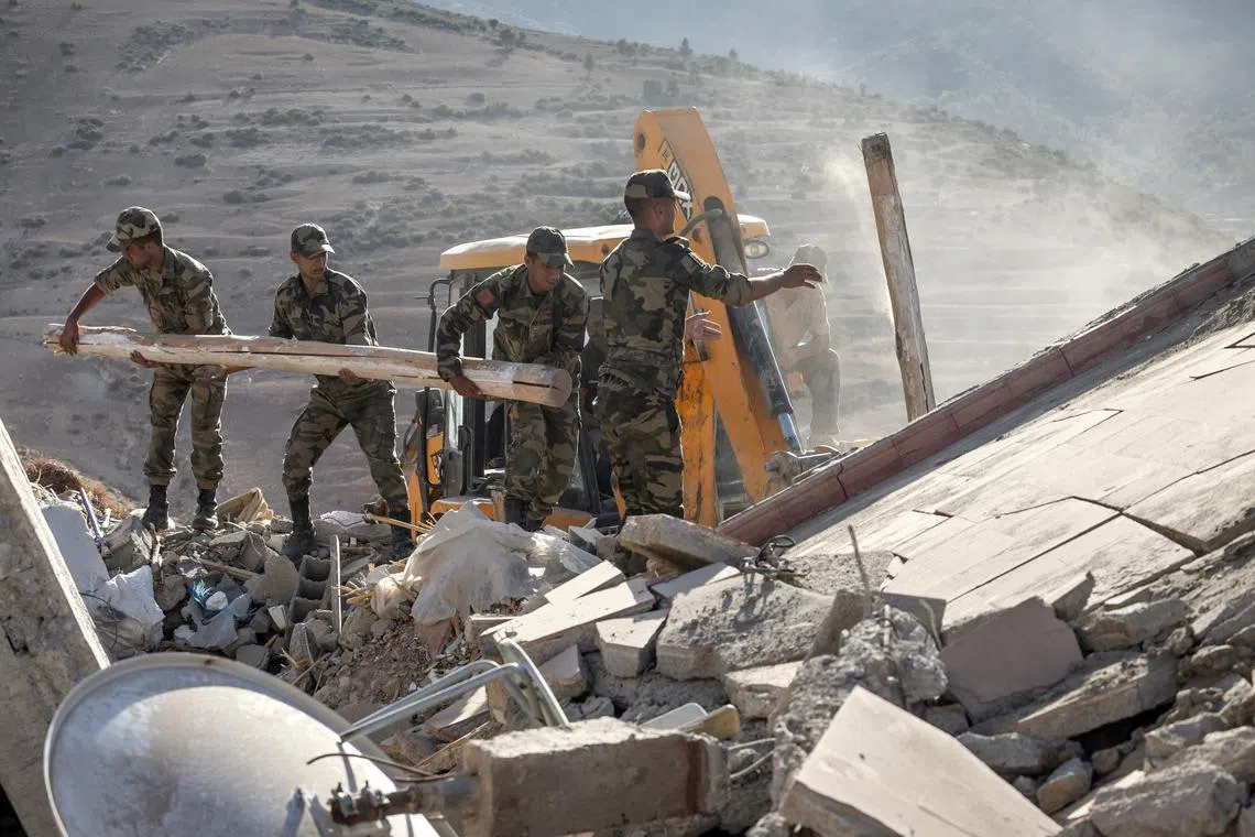 Moroccan Royal Armed Forces search through the rubble of houses after an earthquake in the mountain village of Tafeghaghte, southwest of the city of Marrakesh, on Sept 9, 2023.