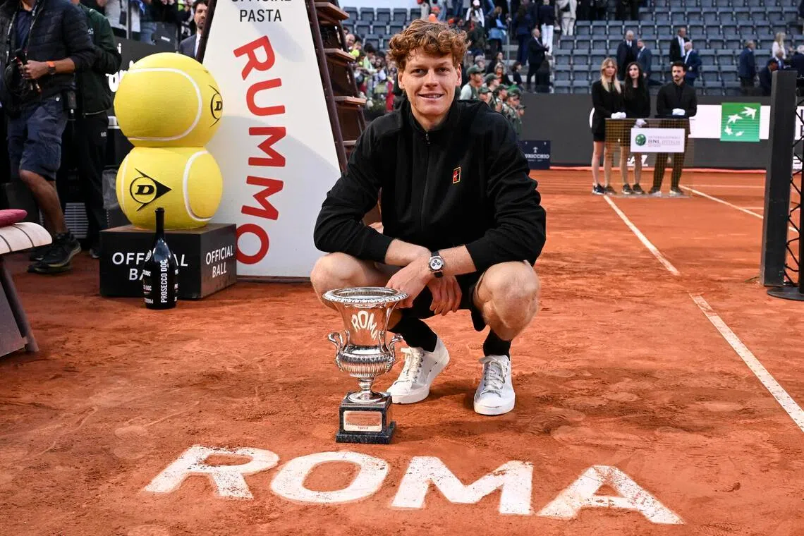 Jannik Sinner poses with the trophy after winning the Italian Open.