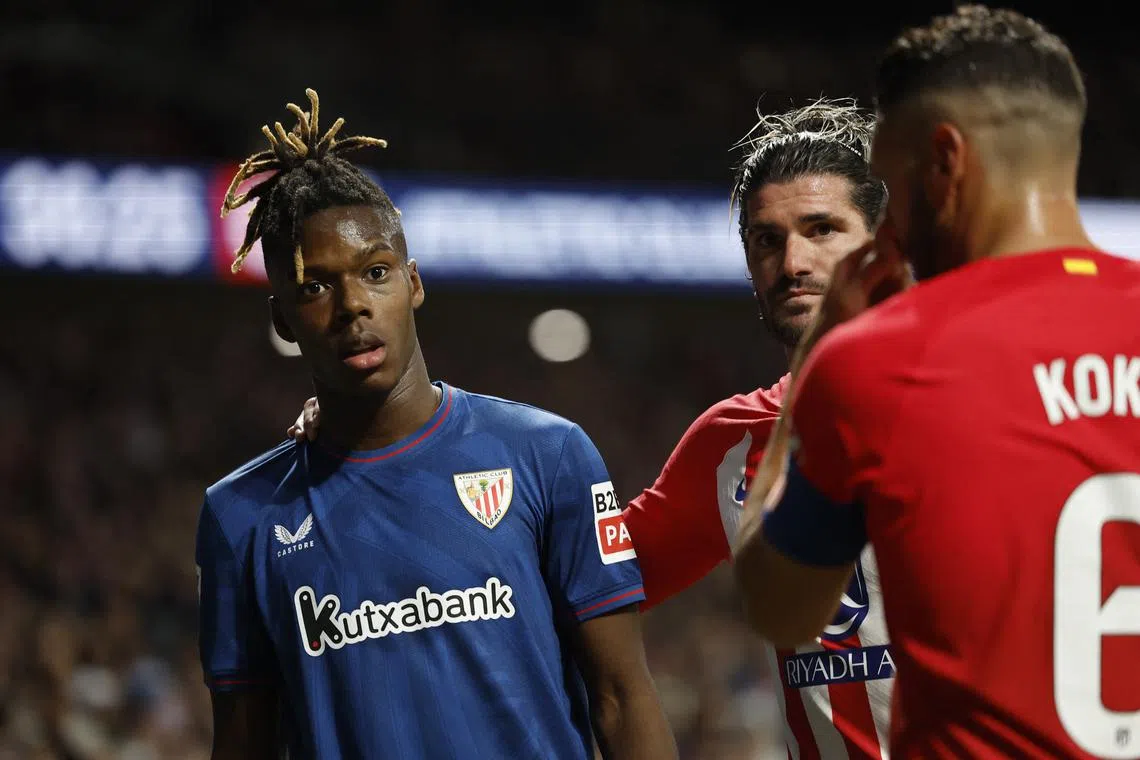 Soccer Football - LaLiga - Atletico Madrid v Athletic Bilbao - Metropolitano, Madrid, Spain - April 27, 2024 Athletic Bilbao's Nico Williams reacts with Atletico Madrid's Rodrigo De Paul and Koke after receiving racist abuse from the crowd REUTERS/Juan Medina