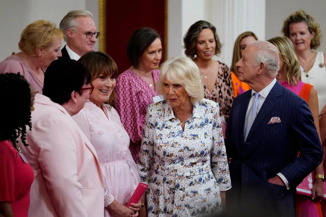 Britain's King Charles and Queen Camilla speak with presenter Lorraine Kelly and the members of the Change + Check Choir, during a reception in Buckingham Palace, London, Britain, April 30, 2025. Andrew Matthews/Pool via REUTERS