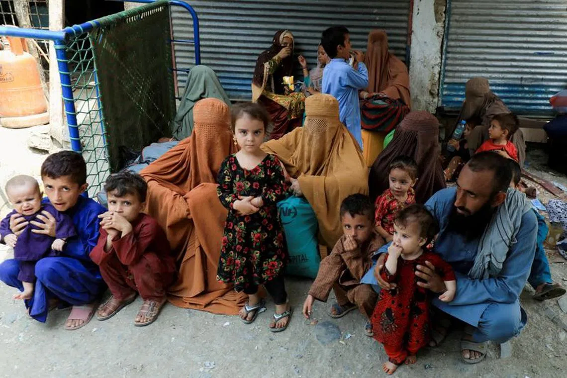 FILE PHOTO: Muhammad Ismail, 40, sits with his family while they are waiting to cross main Afghanistan-Pakistan land border crossing, in Torkham, Pakistan September 15, 2023. REUTERS/Fayaz Aziz/File Photo