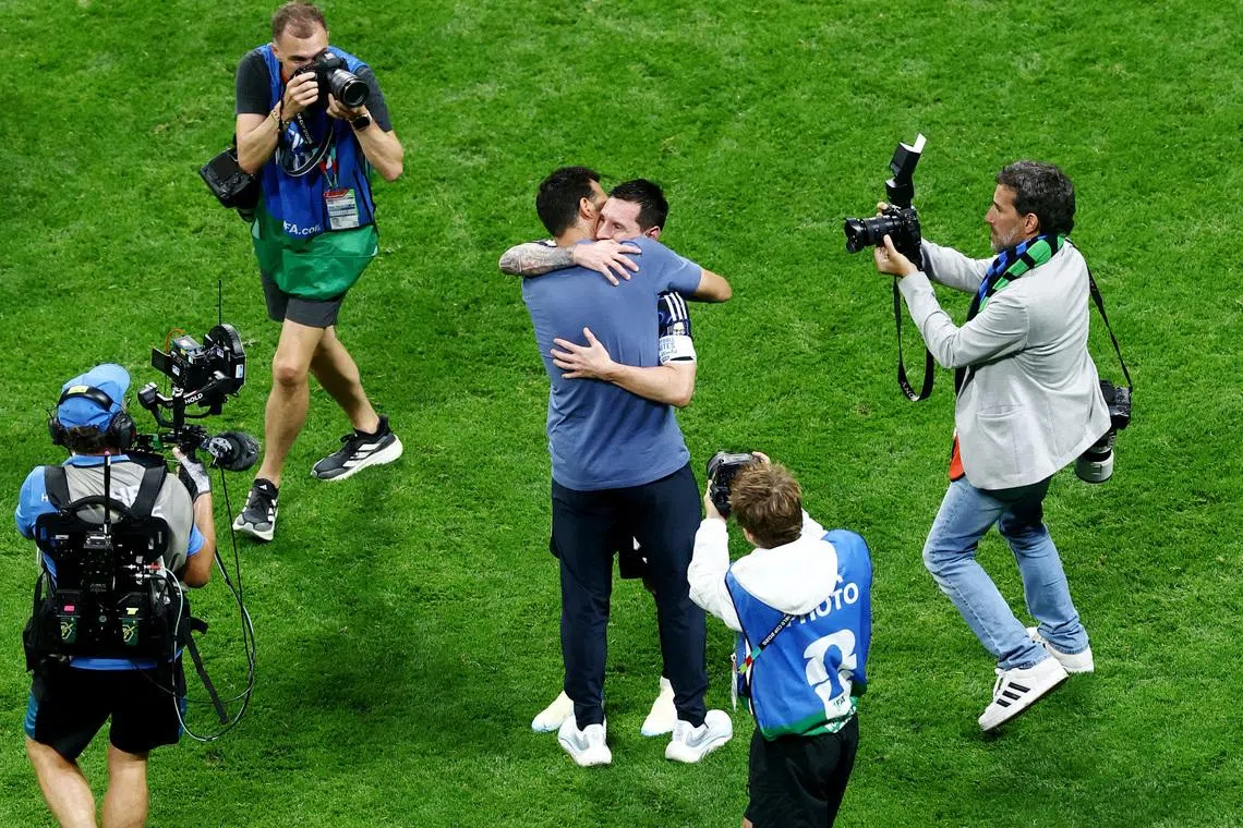 Argentina’s Lionel Messi and coach Lionel Scaloni embrace after Argentina reach the World Cup final.