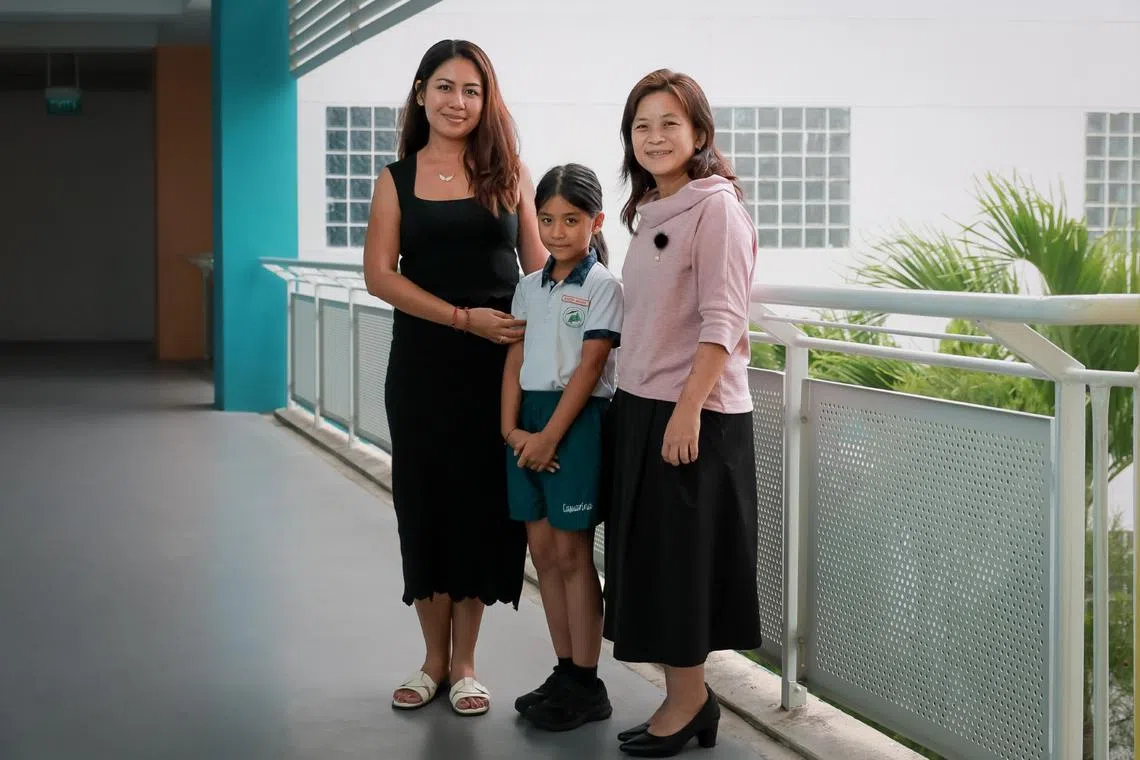 Casuarina Primary School pupil Marisha Michael, eight, with her mother Sasha Iqubal (left) and teacher Ho-Tan Chay Shwan.