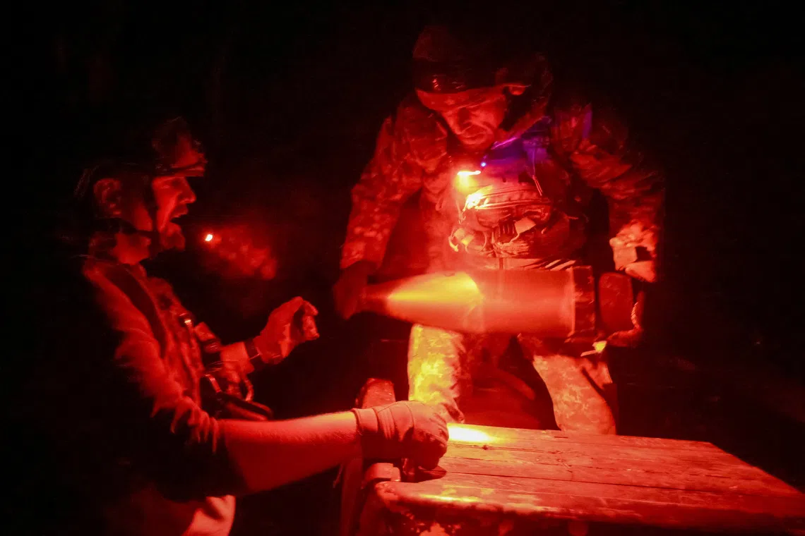 Artillerymen of the 152nd Separate Jaeger Brigade unload shells for an M114 self-propelled howitzer, amid Russia's attack on Ukraine, near the frontline town of Pokrovsk in Donetsk region, Ukraine October 14, 2025. REUTERS/Anatolii Stepanov