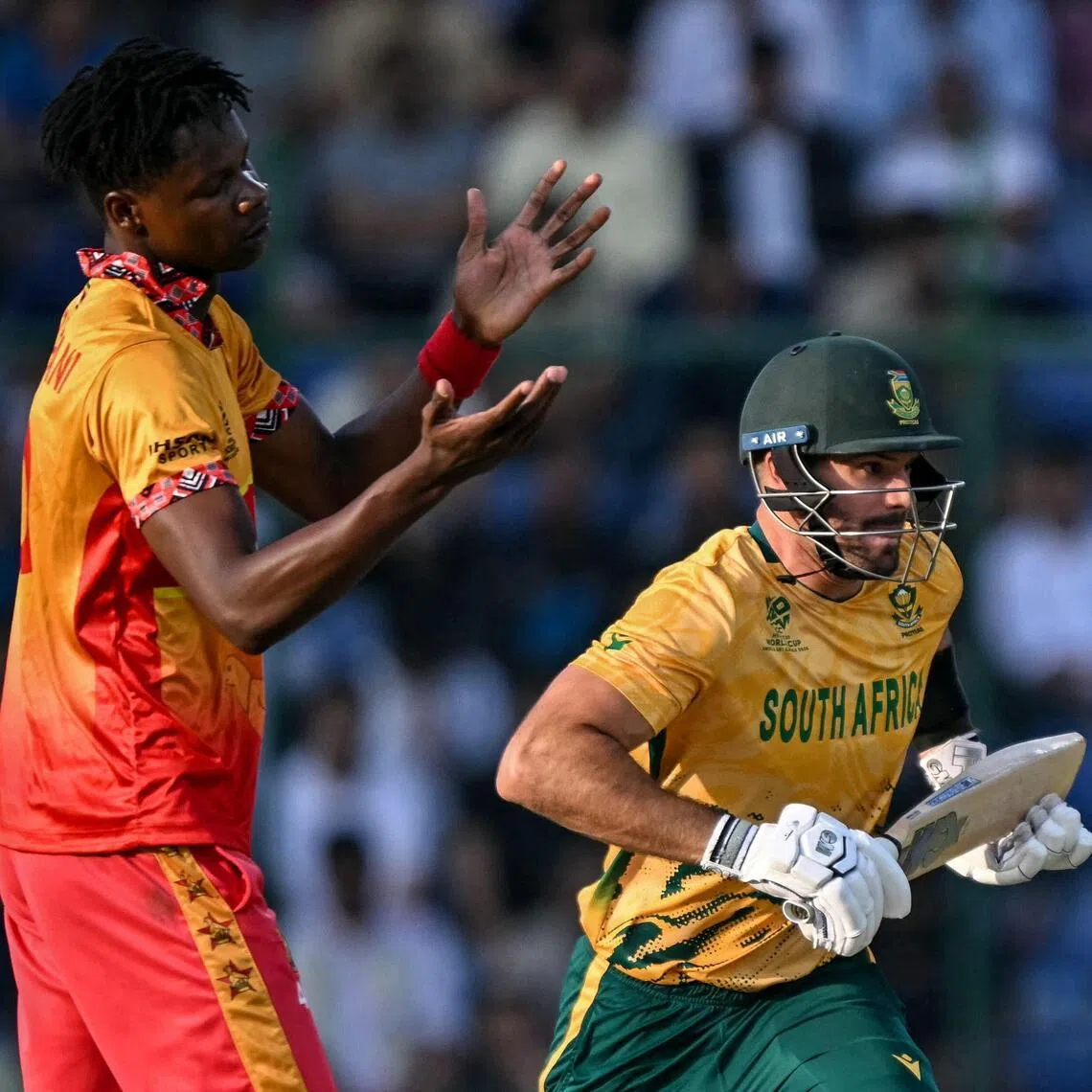 South Africa's captain Aiden Markram runs between the wickets as Zimbabwe's Blessing Muzarabani reacts in their ICC Men's T20 Cricket World Cup Super Eights match at the Arun Jaitley Stadium in New Delhi on March 1, 2026.