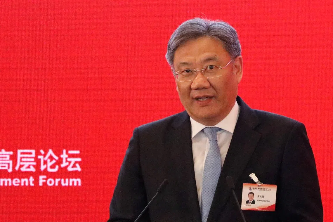 FILE PHOTO: China's Commerce Minister Wang Wentao delivers a speech at the China Development Forum 2023, in Beijing, China, March 26, 2023. REUTERS/Jing Xu/File Photo