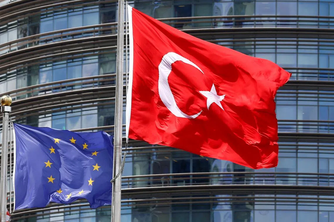 FILE PHOTO: A European Union (L) and Turkish flag fly outside a hotel in Istanbul, Turkey, May 4, 2016.  REUTERS/Murad Sezer/File Photo