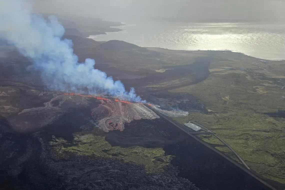 Smoke spews as a volcano errupts near Grindavik in Iceland on April 1, 2025.  