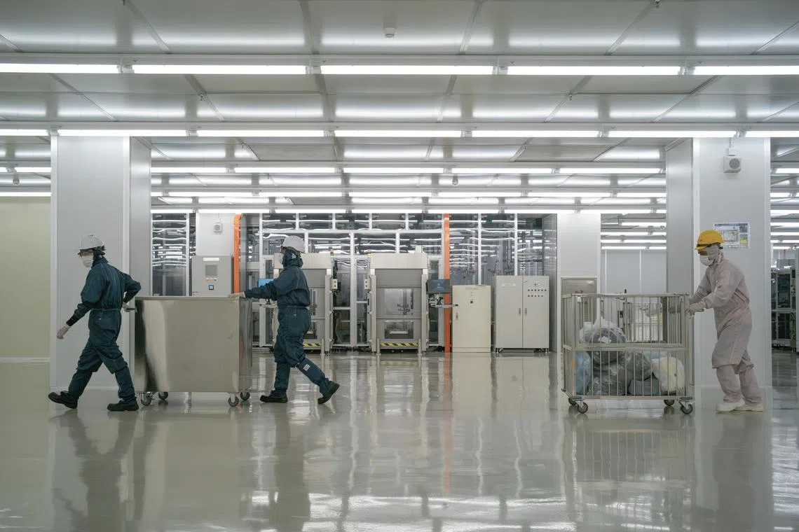 **EMBARGO: No electronic distribution, Web posting or street sales before Wednesday at 12:01 a.m. ET on March 13, 2024. No exceptions for any reasons. EMBARGO set by source.** Employees work inside a clean room at a facility operated by AT&S, an Austrian chip maker, in Penang, Malaysia on Feb. 22, 2024. AT&S, whose largest plant is in China, started looking to diversify locations in 2020.  (Jes Aznar/The New York Times)