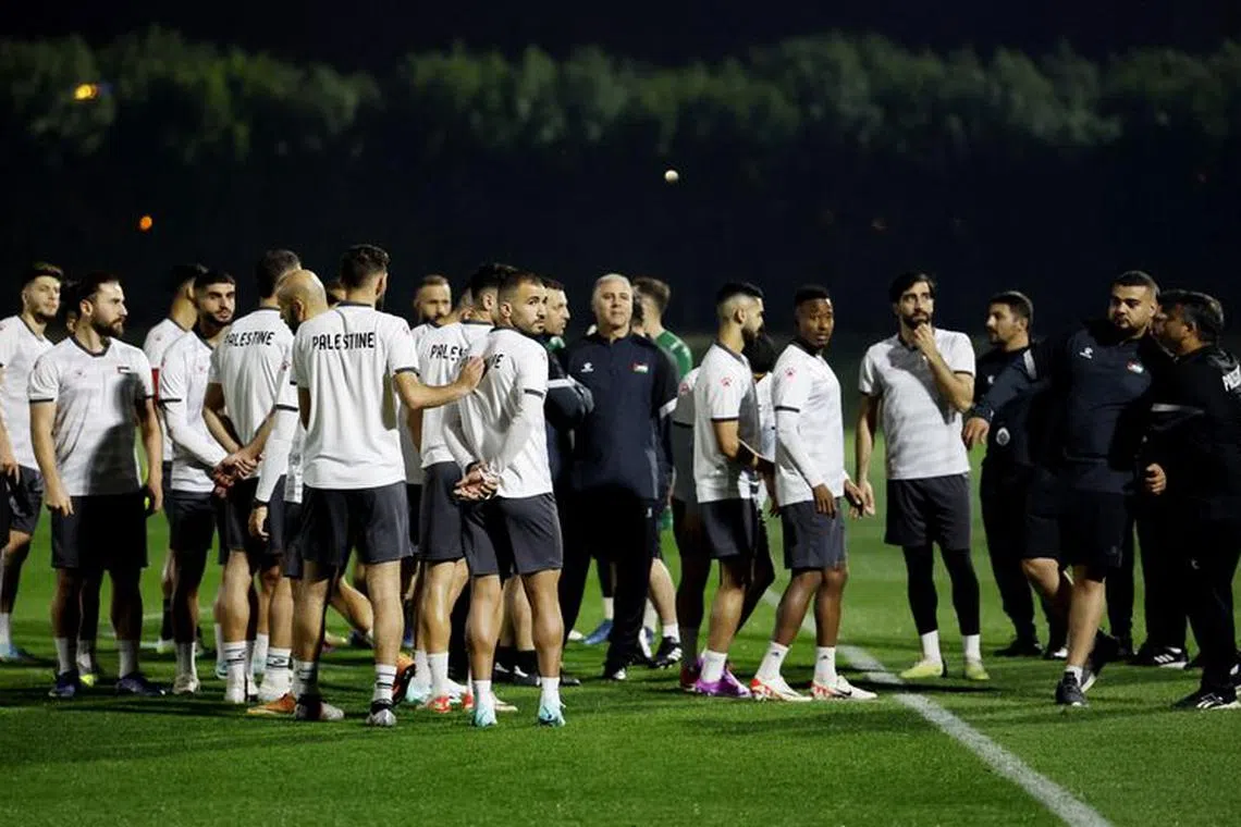 Soccer Football - AFC Asian Cup - Palestine Training - Onaiza Park, Doha, Qatar - January 11, 2024 Palestine coach Makram Daboub with his players during training REUTERS/Thaier Al-Sudani