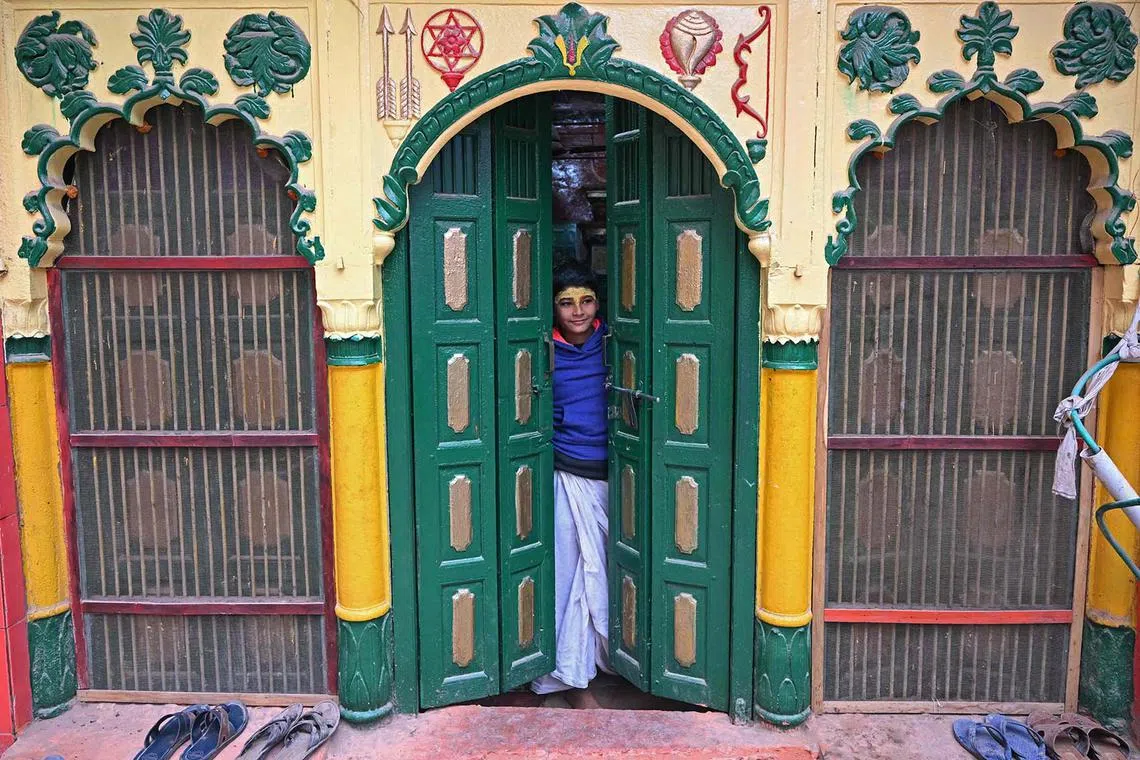 A boy standing at the doorstep of a temple in Ayodhya on Dec 28, 2023. 