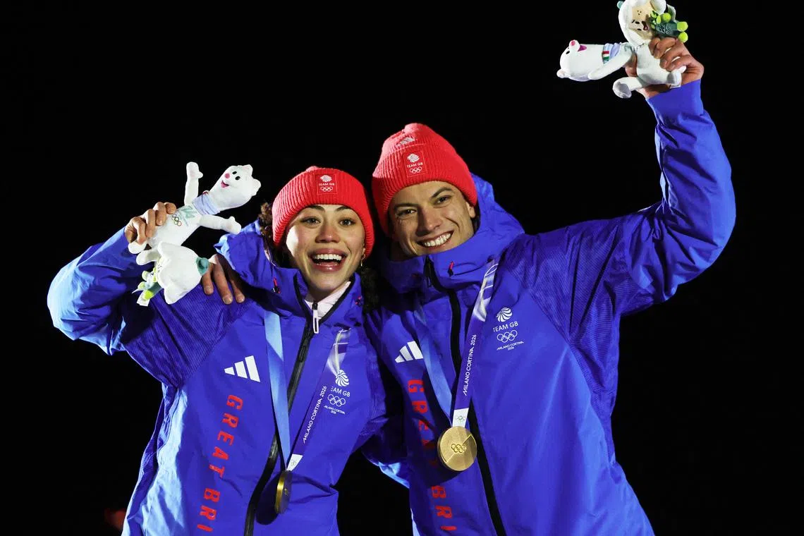 Milano Cortina 2026 Olympics - Skeleton - Mixed Team Victory Ceremony - Cortina Sliding Centre, Cortina d'Ampezzo, Italy - February 15, 2026. Gold medallists Tabitha Stoecker of Britain and Matt Weston of Britain celebrate on the podium during the Skeleton Mixed Team Victory Ceremony. REUTERS/Athit Perawongmetha