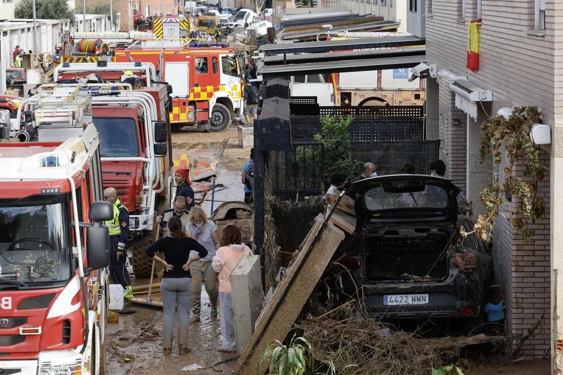 epa11696971 Several firefighting vehicles parked at a residential area affected by flash floods in the town of Alfafar, in Valencia, eastern Spain, 02 November 2024. According to the Integrated Operational Coordination Center (CECOPI), more than 200 people have died in Valencia and neighboring provinces after floods caused by a DANA (high-altitude isolated depression) weather phenomenon hit the east of the country. According to Spain's national weather agency (AEMET), on 29 October 2024 Valencia received a year's worth of rain, causing flash floods that destroyed homes and swept away vehicles.  EPA-EFE/Kai Forsterling