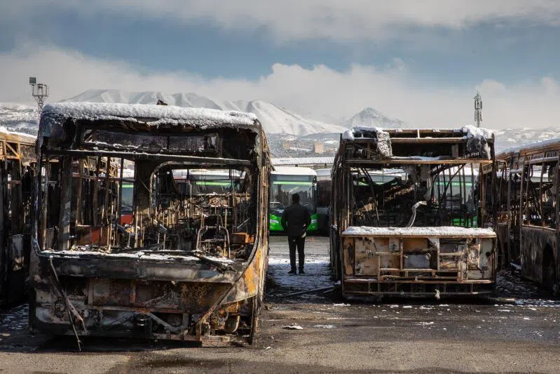 A lot full of buses burned during protests, seen during a tour for international news media in Tehran, Iran, on Jan 21, 2026. 