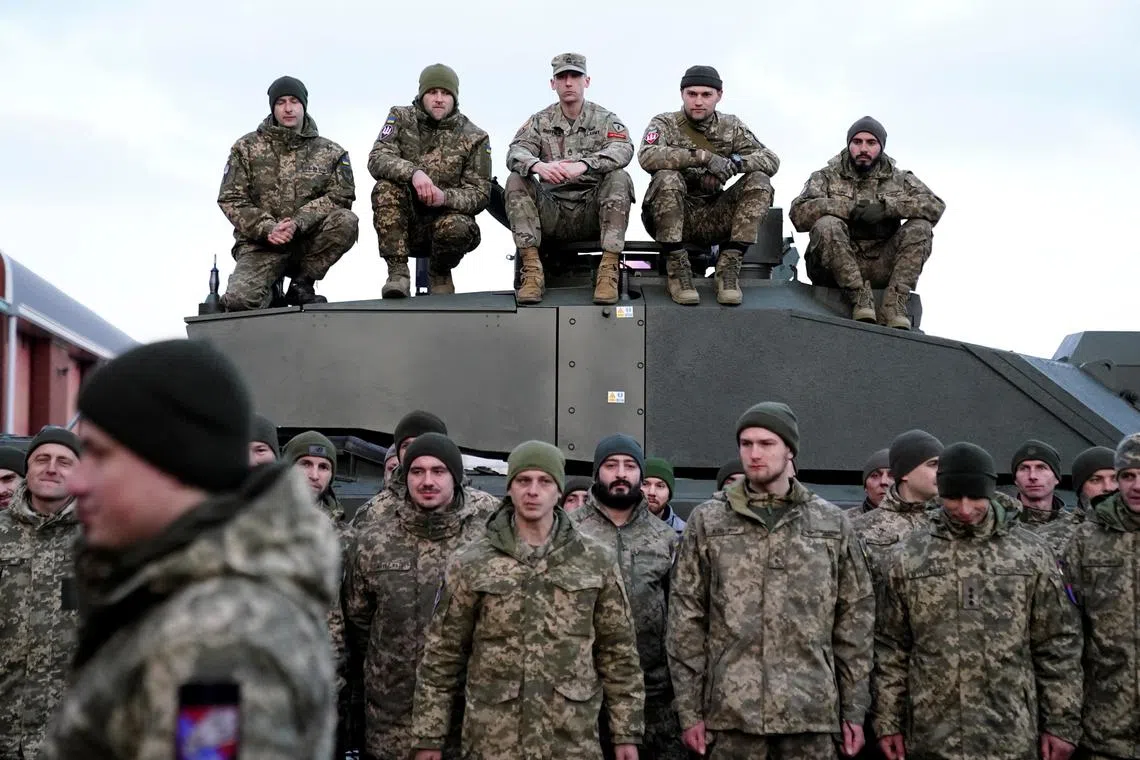 Soldiers gather as Ukrainian President Volodymyr Zelenskiy and British Prime Minister Rishi Sunak meet Ukrainian troops being trained to command Challenger 2 tanks during his first visit to the UK since the Russian invasion of Ukraine at a military facility in Lulworth, Dorset, Britain Wednesday February 8, 2023. Andrew Matthews/Pool via REUTERS