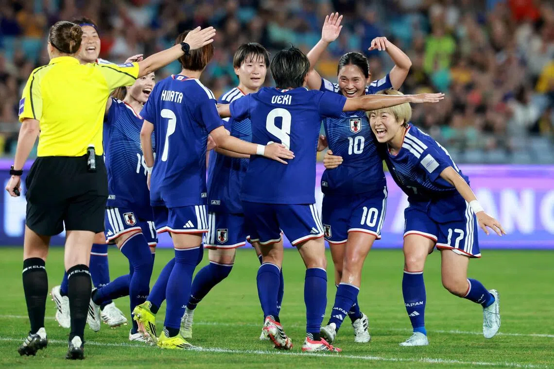 Japan's Riko Ueki celebrates with teammates after scoring a goal in the Women's Asian Cup semi-final against South Korea.