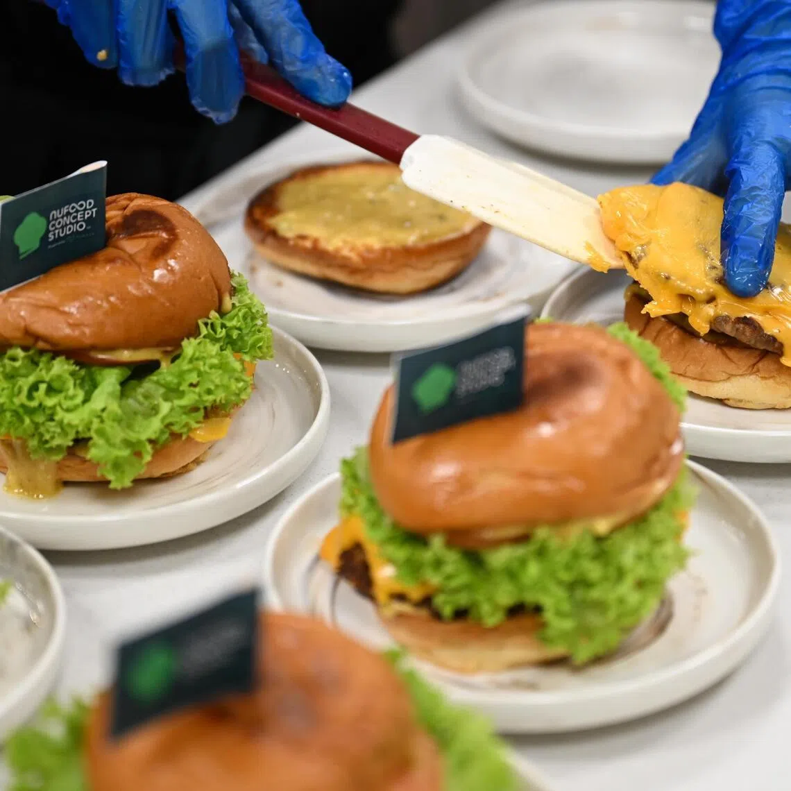 Burgers made with Q Protein’s beef patty with cheese, a blend of premium beef mince, soya-based protein and shredded cheese. 
