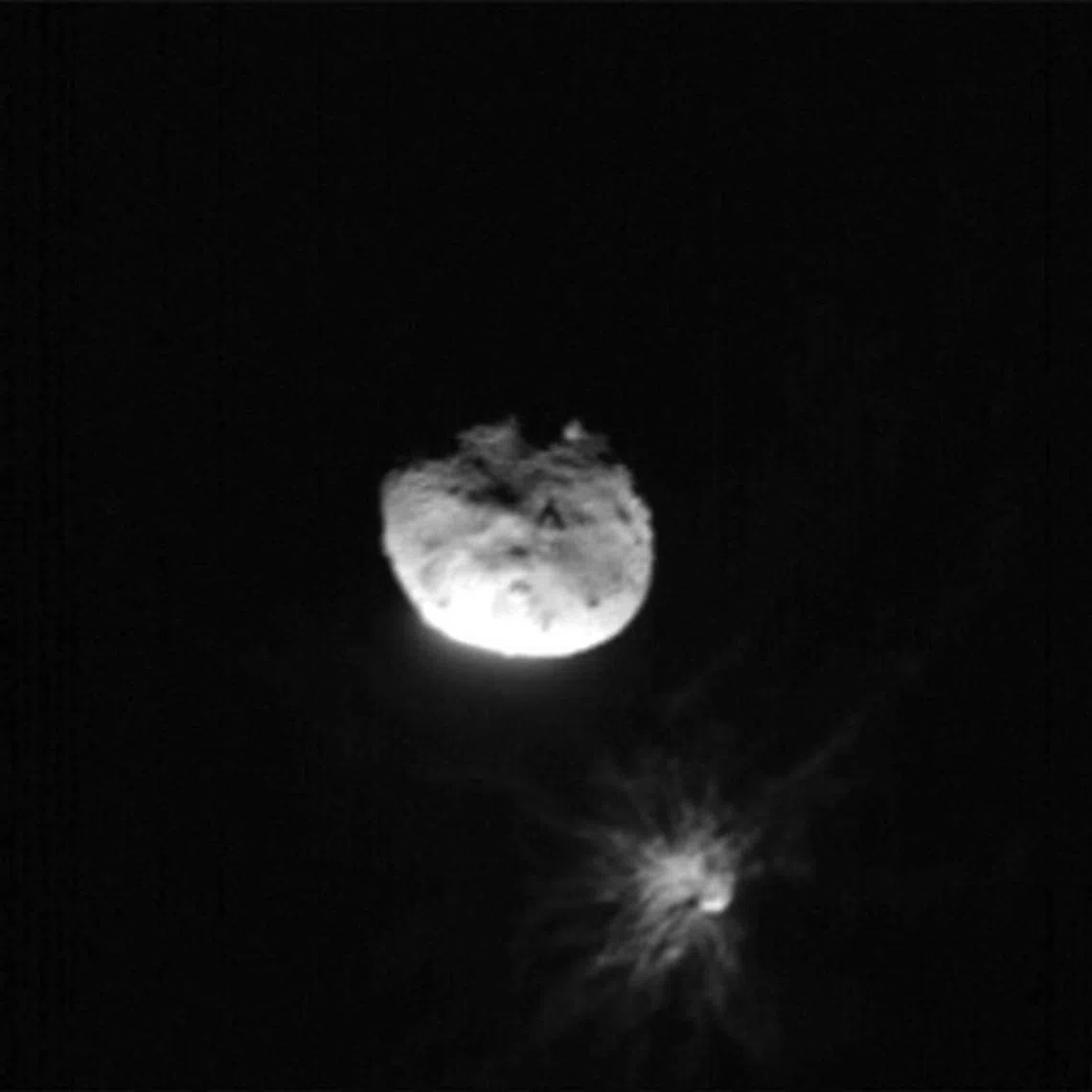 FILE PHOTO: View of Didymos, Dimorphos, and the plume coming off of Dimorphos after the Double Asteroid Redirect Test, or DART mission, purposefully made impact, in this image acquired by ASI's LICIACube satellite just before its closest approach to the Dimorphos asteroid, September 26, 2022. ASI/NASA/Handout via REUTERS/File Photo