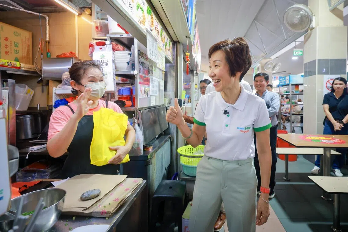 Minister Grace Fu meeting hawkers and distributing care packs at Beo Crescent Market on Oct 22.