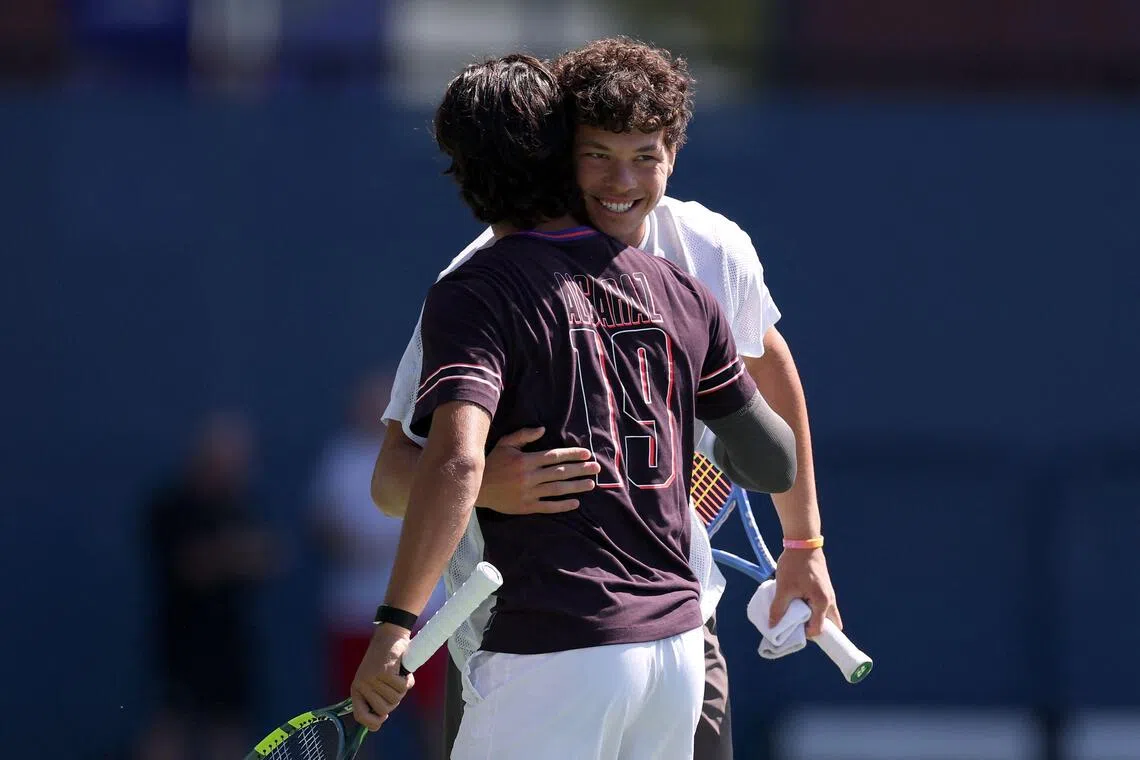 American Ben Shelton (in white) and Carlos Alcaraz of Spain embracing at a practice session during US Open Fan Week on Aug 25 in New York.