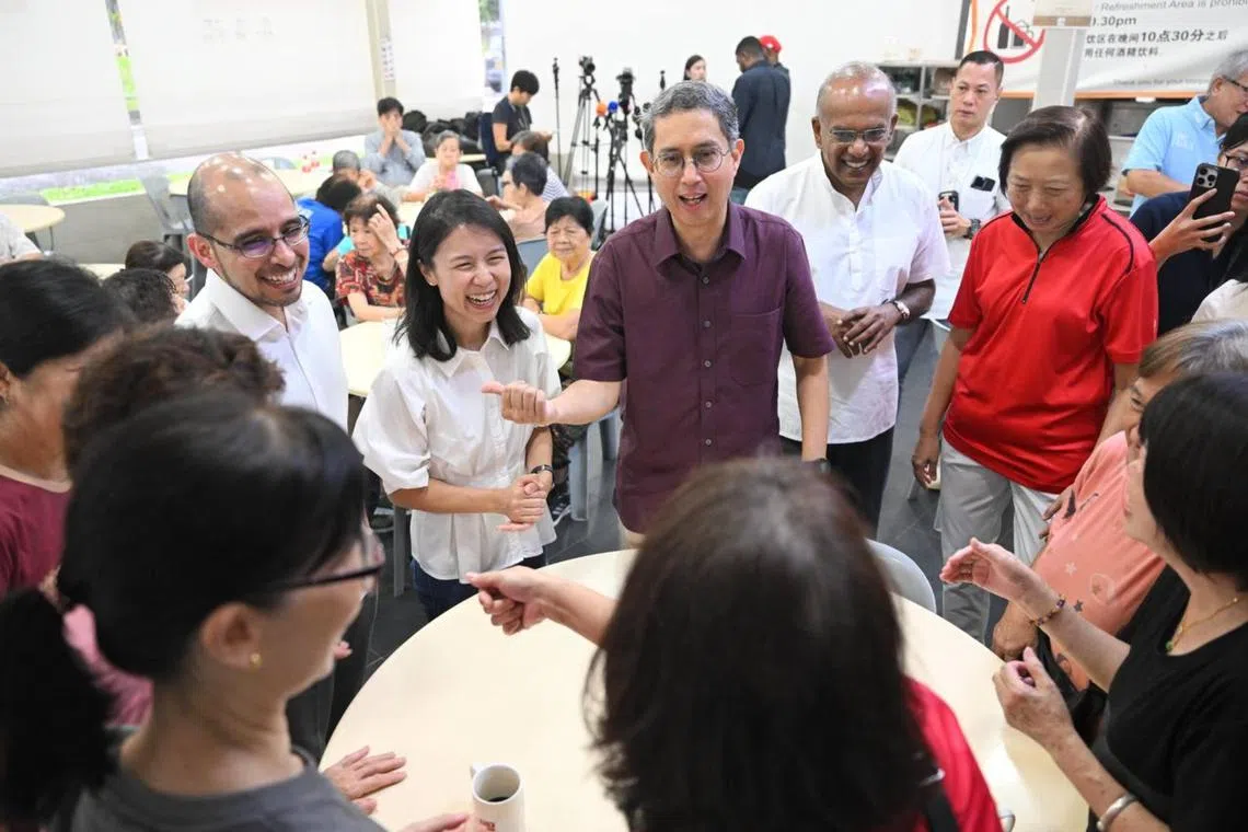 (From left) Former Nominated MP Syed Harun Alhabsyi, Ms Goh Hanyan, a former director at MDDI, Associate Professor Faishal and Home Affairs and Law Minister K. Shanmugam interacting with residents at a coffeeshop at Block 747 Yishun Street 72 on April 11.