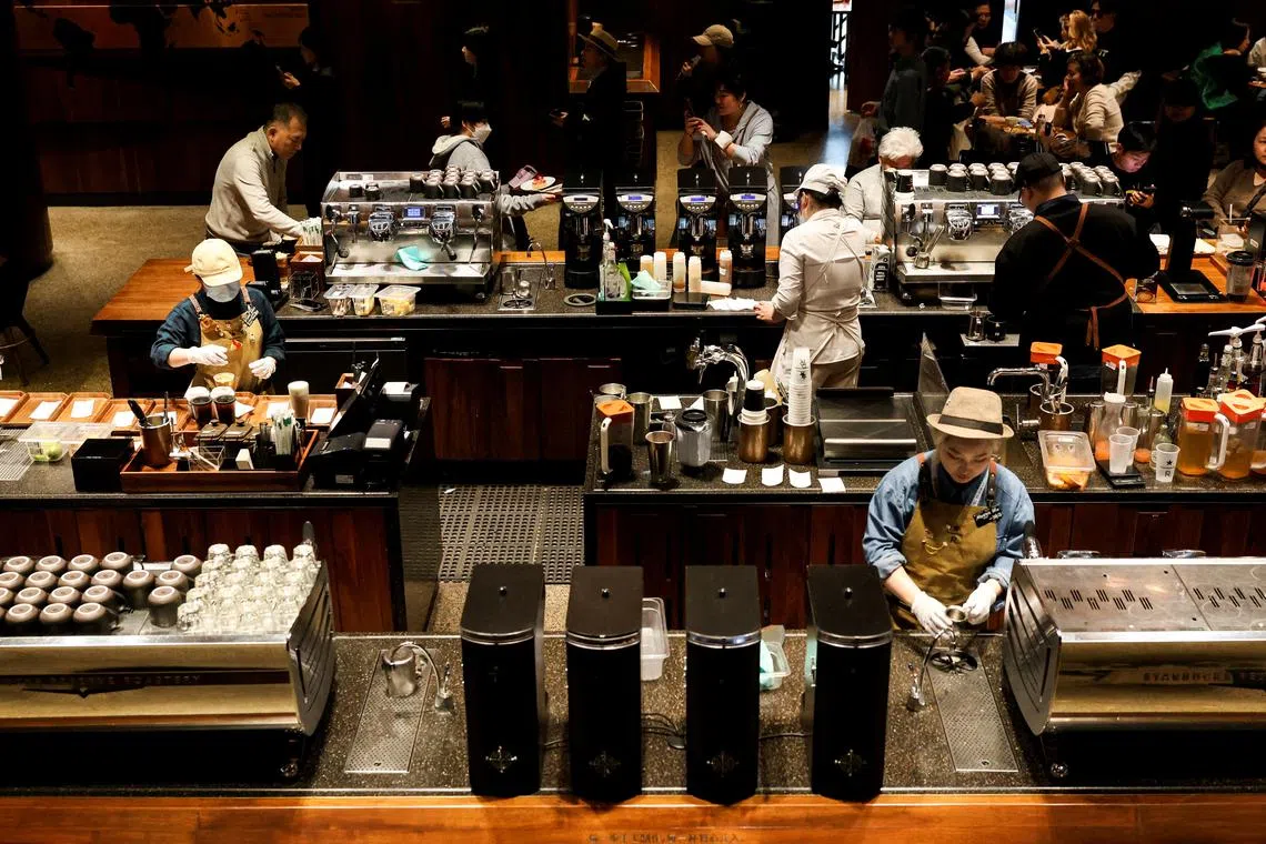 Baristas work to make drinks in Starbucks Reserve Roastery, the largest Starbucks shop in the world, in Shanghai, on Feb 28.