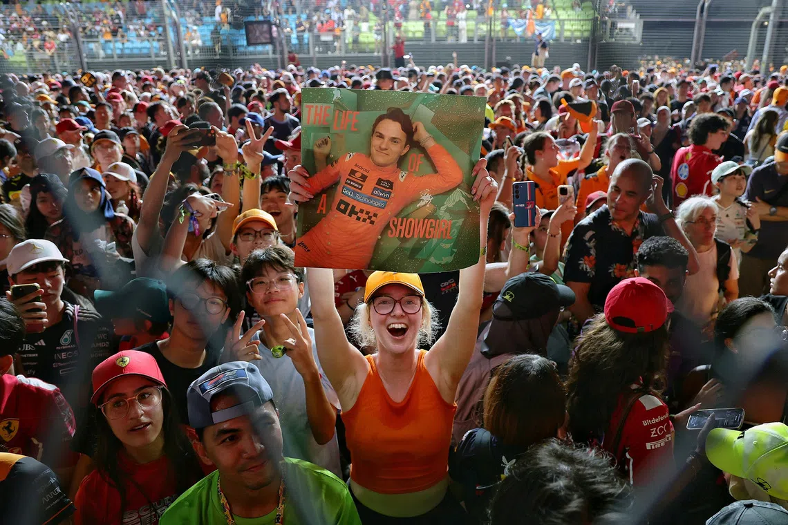 A fan of McLaren driver Oscar Piastri holding a poster of him at the 2025 Formula One Singapore Airlines Singapore Grand Prix at the Marina Bay Street Circuit on Oct 5, 2025.