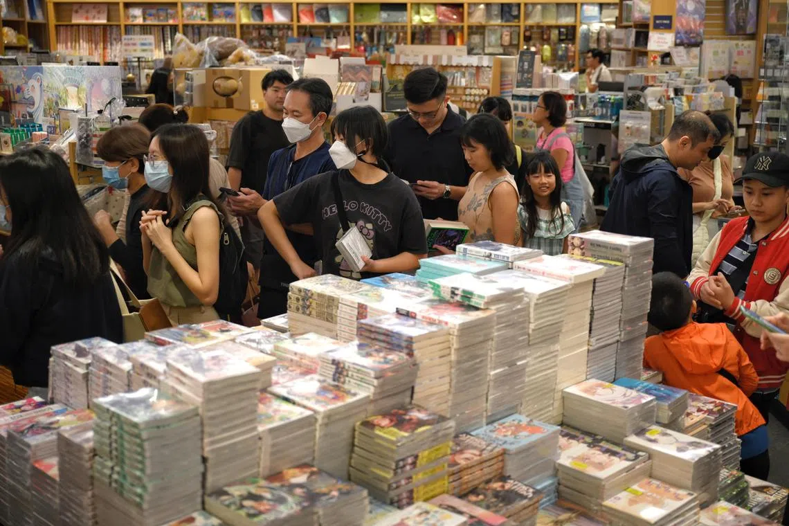 People shop for books at Books Kinokuniya in Orchard on December 23, 2023.
