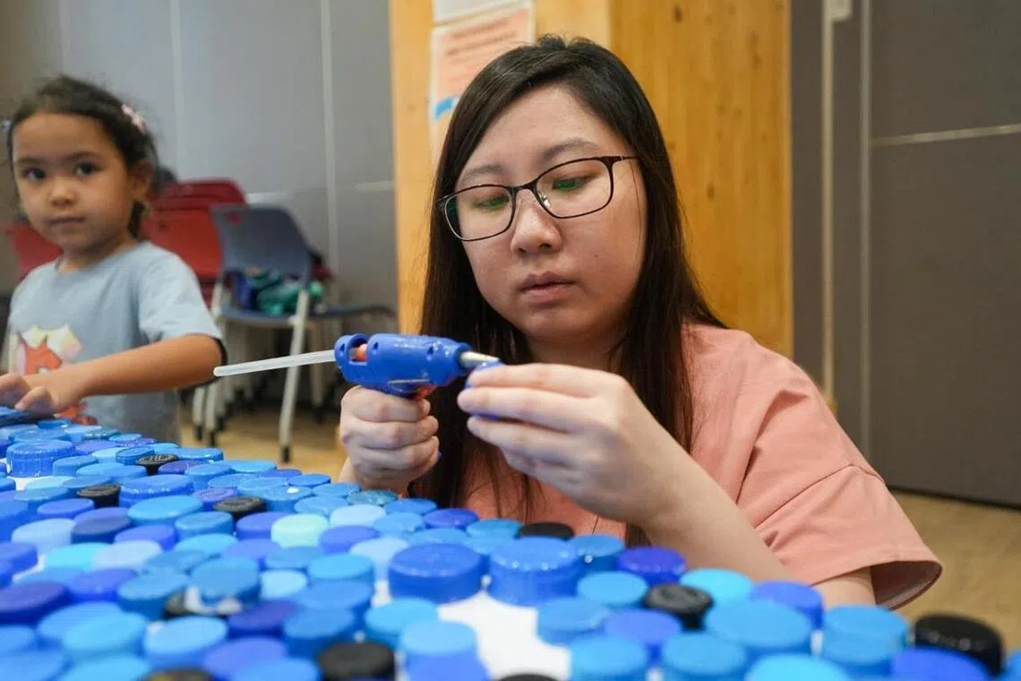Rivervale Shores Residents’ Network vice-chairperson Melissa Tan, 32, working on the artwork.